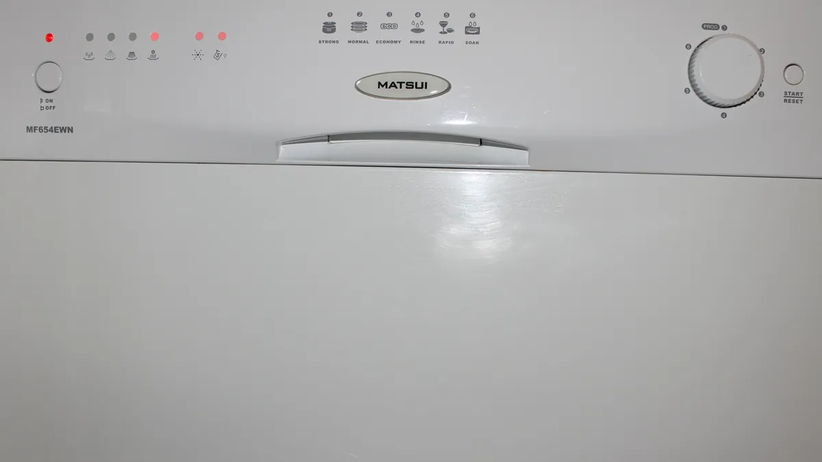 Front of a white dishwasher with a row of buttons and a cycle dial
