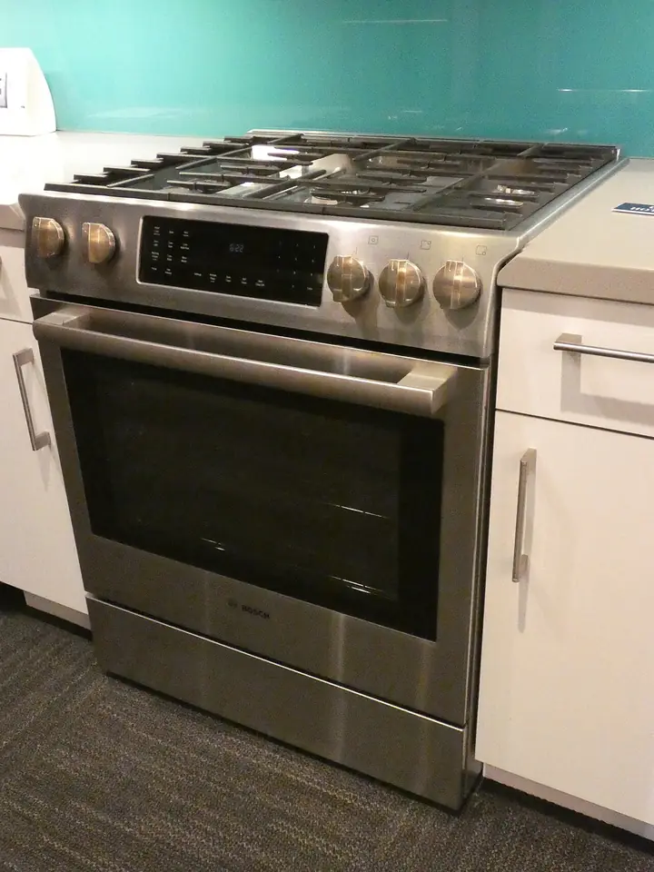 Freestanding stainless gas range with an oven below the burners